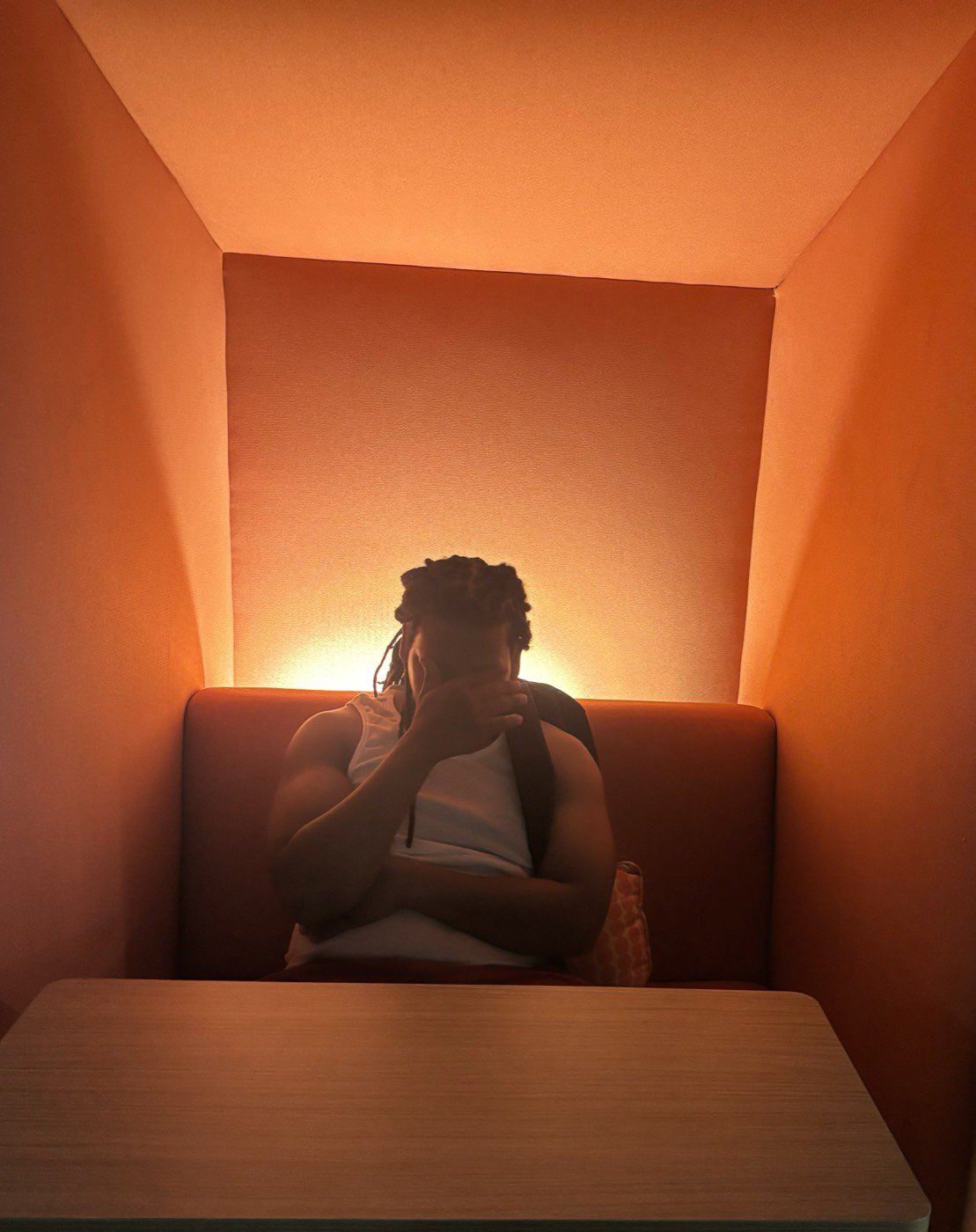 Sl1ck N°1 silhouette in orange booth lighting